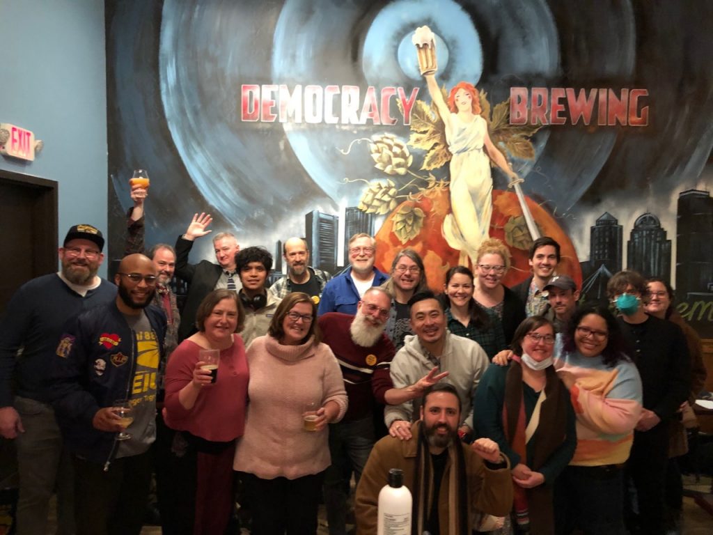 Group of Emerson SEIU 888 members smiling at Democracy Brewing