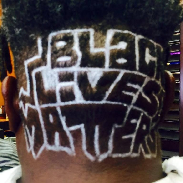 The back of a head with "BLACK LIVES MATTER" visible on it.